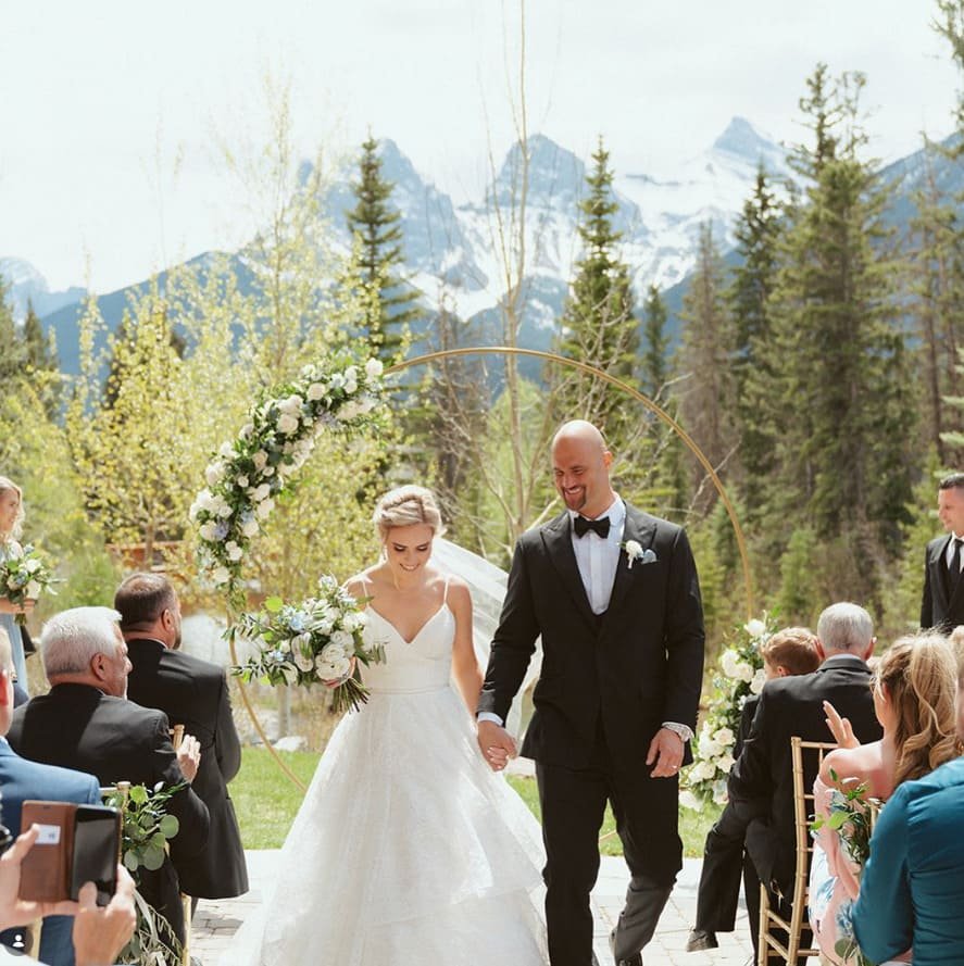 Luxury wedding floral arrangements and table setting for a mountain-view reception at The Malcolm Hotel, Canmore.
